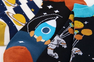 Close-up of cotton socks with astronaut themes, space patterns, and reinforced heels