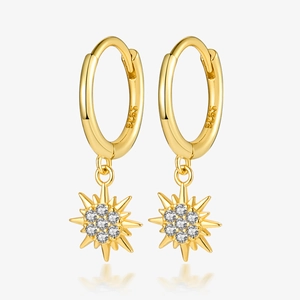 Macro view of gold S925 sterling silver star drop earrings with sparkling zircon