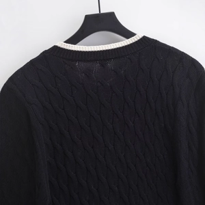 Chic black cable knit cardigan for women with contrasting cream crew neck detail