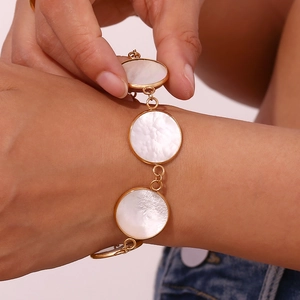 Detail of 18K gold plated bracelet with OT buckle and round natural mother of pearl inlay