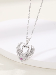 Detail of silver swan heart necklace with pink gemstone and sparkling crystals