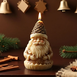 Artistic Santa Claus candle with pine cone hat and glitter details in warm festive decor