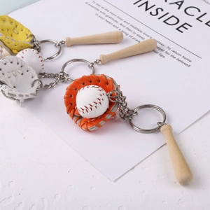 Detailed set of baseball glove, ball, and wooden bat keychains on a poetic background
