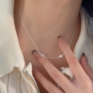 Detailed close-up of a 925 sterling silver necklace featuring a pearl and crystal bead