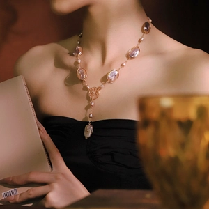 Elegant Y-shaped necklace with pink Baroque pearls and gold wire on a model