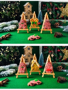 Detailed Christmas cookies on mini wooden easels with gingerbread man and cane shapes