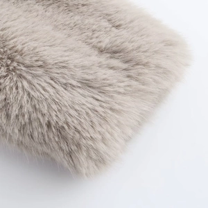 Macro shot showing fluffy long-pile faux fur texture and soft gray fibers of the jacket