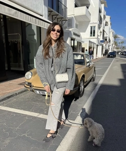 Street style view of a grey oversized wool coat styled with a quilted chain bag
