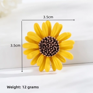 Detailed view showing a 3.5cm sunflower brooch with yellow petals and 12g weight