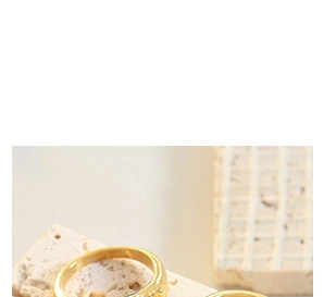 Macro shot of gold plated stackable rings with one smooth band and one pave band