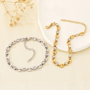 Detail view of coffee bean link bracelets with sparkling zircons in gold and silver finish