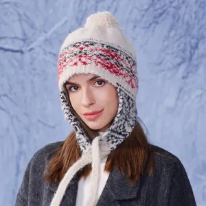 Winter women's knit earflap hat with colorful patterns and a white pom-pom