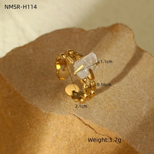 Macro shot of gold-plated ring with raw white stone and detailed size dimensions
