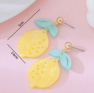 Detailed view of yellow acrylic lemon earrings with blue leaf showing 5cm x 2.6cm dimensions