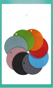 Close-up of honeycomb silicone trivet mats in multiple colors with hanging holes