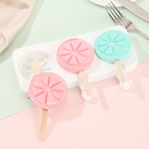 Food-grade silicone popsicle mold with three lemon-shaped ice creams on wooden sticks