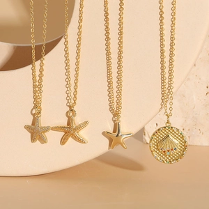 Gold starfish and shell pendant necklace set with cubic zirconia and colored stones