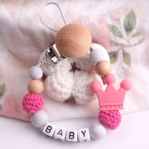Pink and wood beechwood pacifier clip with BABY letters and silicone crown detail