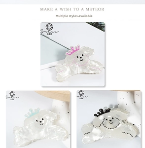 Detailed view of cute cartoon dog hair claw clips with shiny pearl finish and crown detail