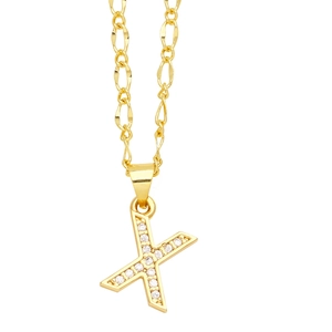 Detailed view of capital letter X pendant with micro-pave cubic zirconia on gold Figaro chain
