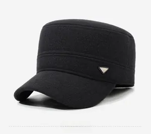 Close-up of black wool flat top cadet cap featuring a metal 'FASHION' triangle logo