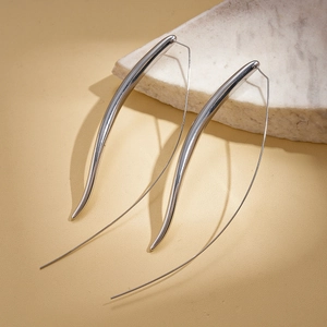 Detailed view of silver teardrop earrings with a sleek metallic finish and long hooks