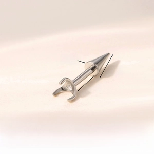 Macro detail of F136 titanium piercing ball accessory with 0.9mm screw and cone head