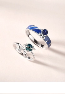 Close-up of S925 silver astronaut rings with blue enamel and sparkling zircon detail