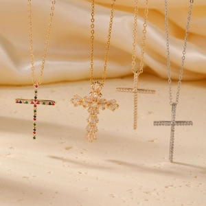 Elegant gold and silver cross necklaces with zircon and crystals on silk fabric