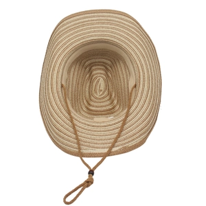 Detail of two-tone woven straw cowboy hat featuring internal sweatband and chin strap