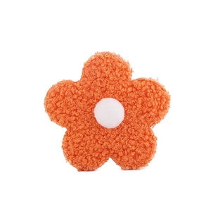 Detail of 8cm orange teddy velvet flower accessory with a soft curly wool texture