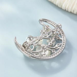 Macro detail of the S925 silver hallmark and pin clasp on the crescent flower brooch