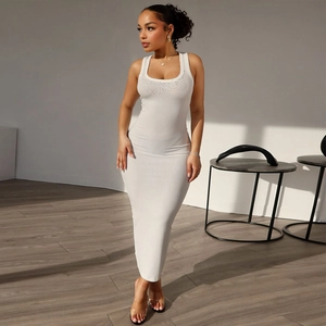Close-up of white knitted ribbed dress with rhinestone neckline and slim fit texture