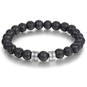 Detailed close-up of custom lava stone beads with engraved names Edison and Valery