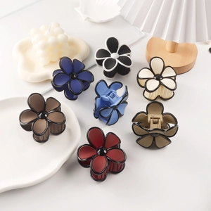 Matte floral hair claws in multiple colors featuring elegant black outlines and center detail