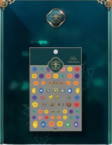 Macro detail of colorful cartoon emoji nail art stickers in deep green packaging
