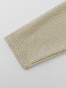 Close-up of khaki waffle knit fabric texture on a long-sleeve casual sweatshirt