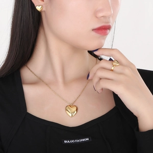 Elegant 18K gold plated stainless steel jewelry set featuring heart necklace and earrings