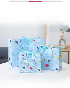 Three-piece set of light blue starry sky paper gift bags with satin ribbon handles