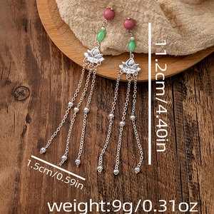 Close-up of long tassel lotus earrings with detailed size and weight specifications