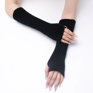 Detail of black knitted fingerless gloves with a long ribbed texture for autumn winter