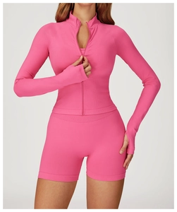 Detail of ribbed hot pink yoga set showing full zipper jacket with thumbholes