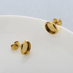 Detailed view of 18K gold-plated circular stud earring bases with butterfly backings
