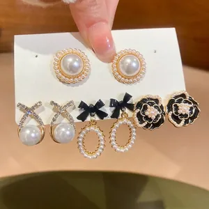 Retro 5-pair pearl and floral earring set featuring crystals and black enamel camellia