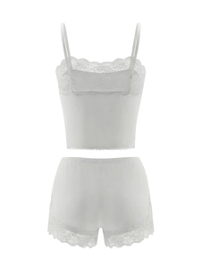 Close-up of white lace trim camisole and shorts set with seamless soft fabric detail