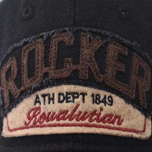 Distressed black cotton baseball cap featuring vintage ROCKER embroidered patch detail