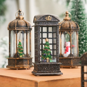 Retro Christmas lantern with festive snowman and tree scene inside a red telephone booth
