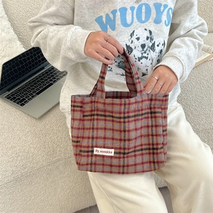 Detail of vintage plaid tote bag made of wool fabric with woven checkered pattern