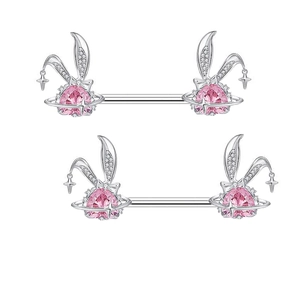 Silver rabbit nipple rings with pink heart gems and cross star pendants on white background