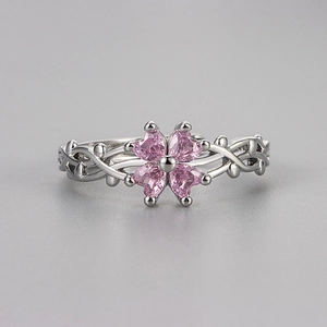 Vintage silver four-leaf clover ring with pink heart stones and vine-wrapped band design